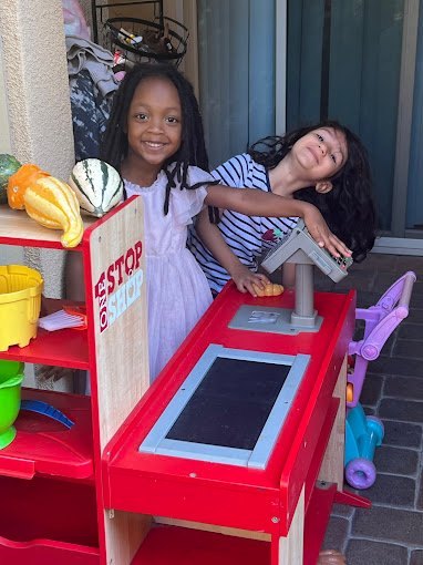Children playing at a pretend market at Happy Palm Daycare Irvine
