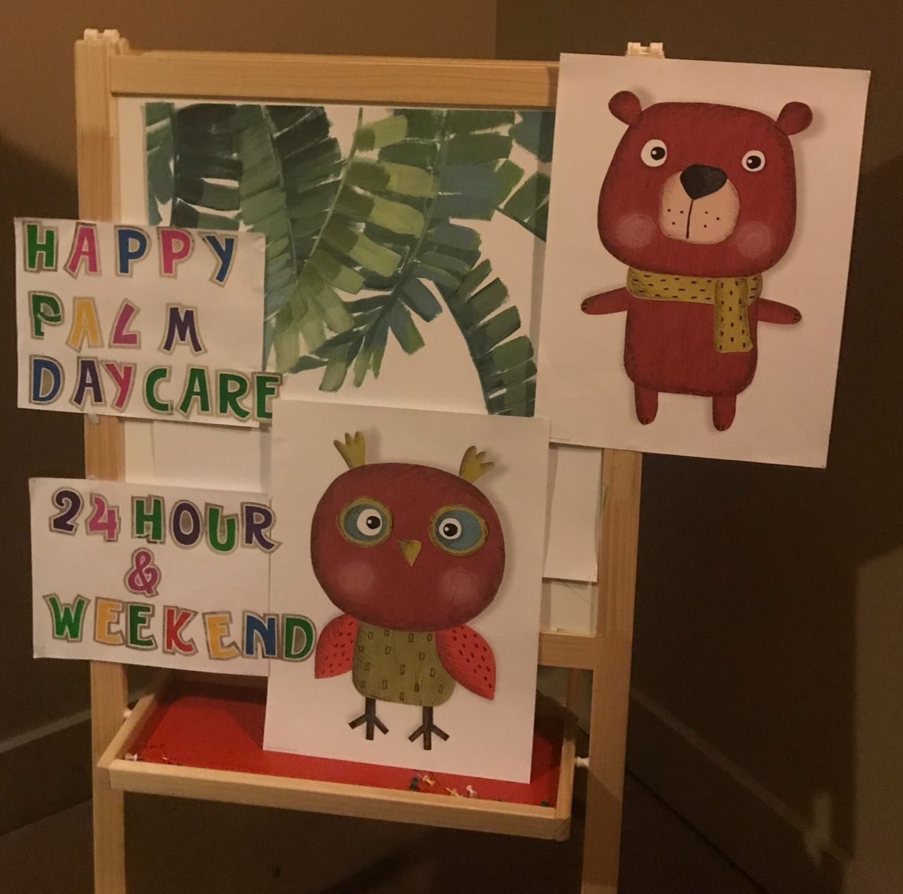 Happy Palm Daycare 24 Hour and Weekend care sign with the bear and owl mascots