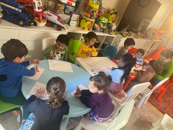 Preschoolers doing arts and early writing at Happy Palm Daycare